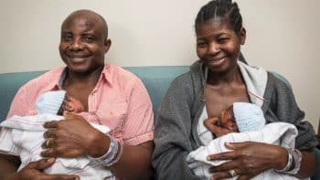 Adeboye and Ajibola Taiwo hold two of their sextuplets on May 23, 2017