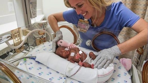 Jamie Burton, RN, repositions one of the taiwo sextuplets