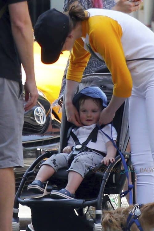 Anne Hathaway and her son Jonathan take their pooch for a stroll