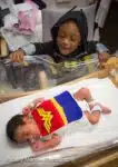 Brother-visits-his-sister-in-her-wonderwoman-costume-NICU-Saint-Luke’s-Hospital-Kansas-City-March-of-Dime