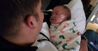 Officer Arturo Zepeda cuddles with Axel.