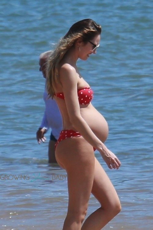 Candice Swanepoel shows off her very large baby bump at the beach