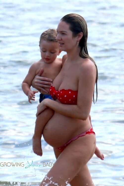 Candice Swanepoel shows off her very large baby bump at the beach with her son