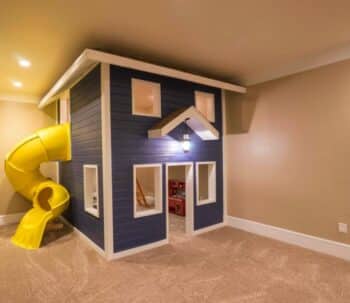 Indoor two story playhouse with slide
