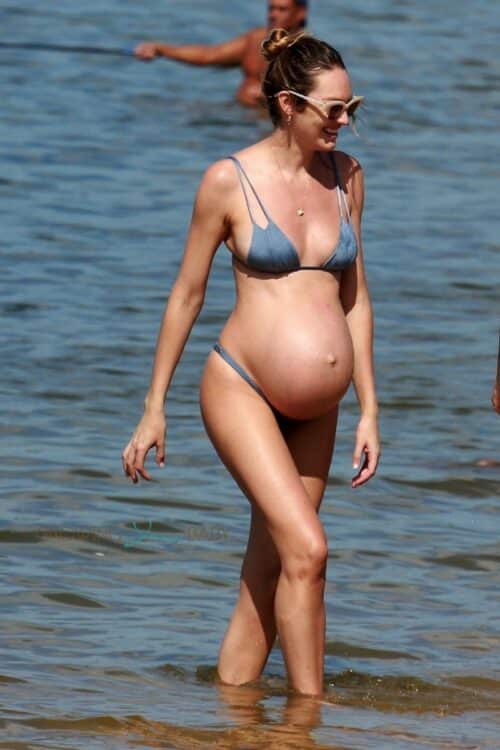 Candice Swanepoel looks like she's ready to pop as she enjoys a day at the beach