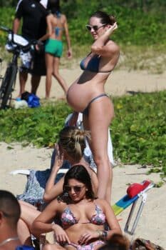 Candice Swanepoel looks like she's ready to pop as she enjoys a day at the beach in Brazil