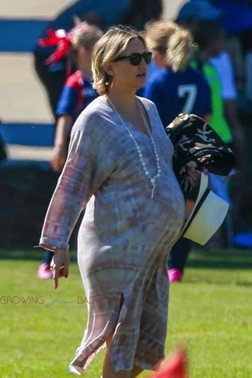 A heavily pregnant Kate Hudson and partner Danny Fujikawa take her son Bingham to soccer practice in Malibu