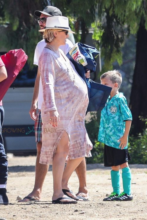 A heavily pregnant Kate Hudson and partner Danny Fujikawa take her son Bingham to soccer practice in Malibu