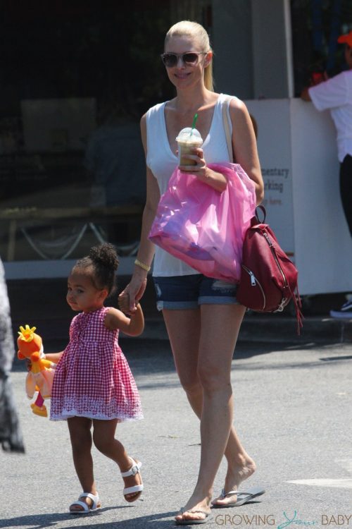 Paige Butcher plays with her daughter outside a Beverly Hills store