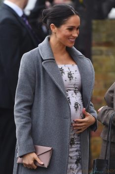 Pregnant Meghan Markle shows off growing baby bump while making a visit to the Royal Variety care home