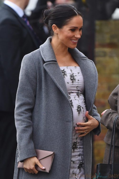 Pregnant Meghan Markle shows off growing baby bump while making a visit to the Royal Variety care home