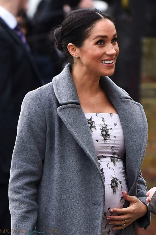 Pregnant Meghan Markle shows off growing baby bump while making a visit to the Royal Variety care home