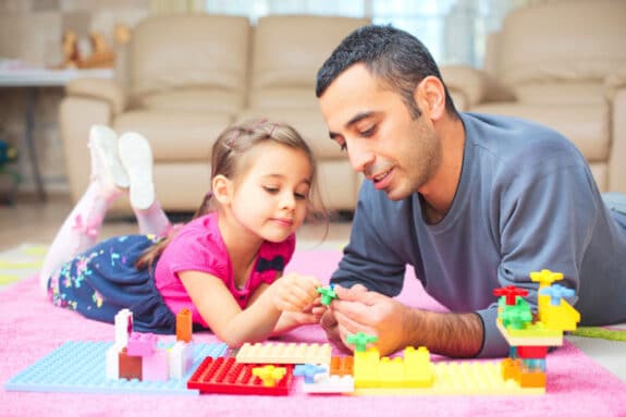 dad playing lego with daughter