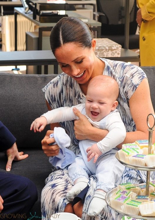 Meghan Markle is seen holding their baby son Archie, during the visit to Archbishop Desmond Tutu - all smiles