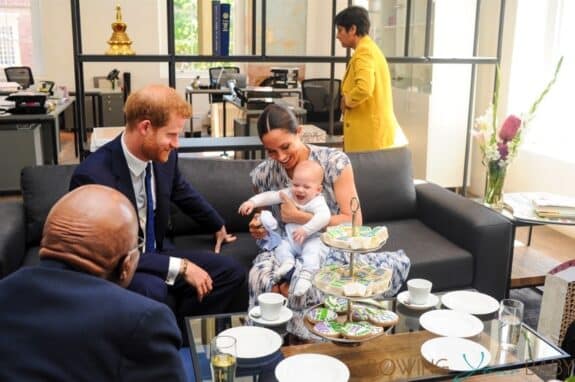 Meghan Markle is seen holding their baby son Archie, during the visit to Archbishop Desmond Tutu - all smiles