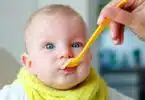 baby eating cereal