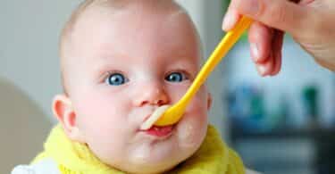 baby eating cereal