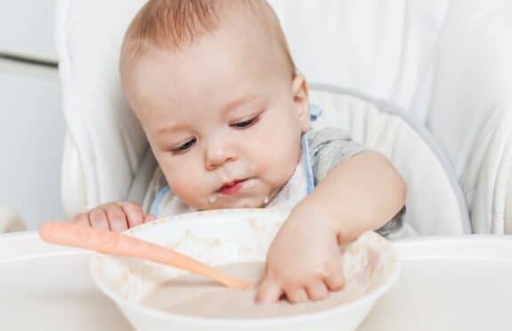 baby eating cereal