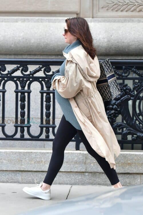 Pregnant Anne Hathaway cradles her growing baby bump in NYC