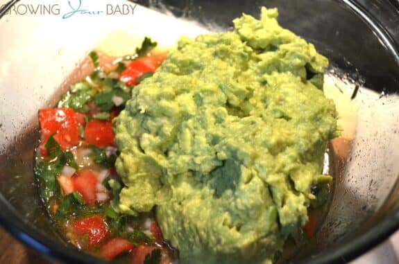 Homemade guacamole - fold avocado into tomatoe mixture