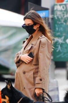 Emily Ratajkowski looks stylish in a trench coat as she shows off her growing baby bump