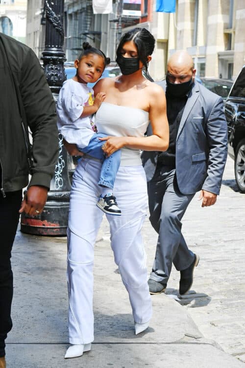 Kylie Jenner carries Stormi after shopping at the American Girl