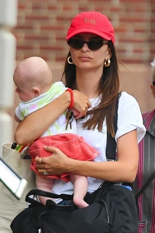 Emily Ratajkowski carries baby Sly as she arrives home