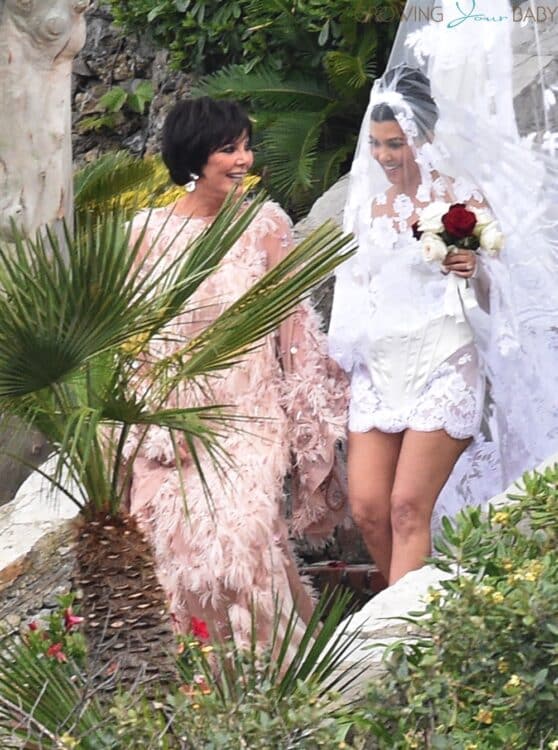 Kourtney Kardashian is seen being guided to her wedding by mother Kris