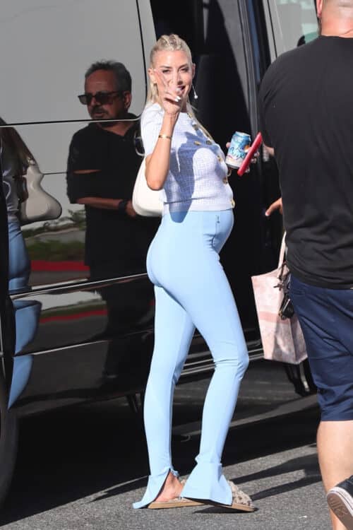 pregnant woman wearing a blue outfit smiling