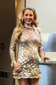 pregnant blake lively wearing a gold dress with a baby bump