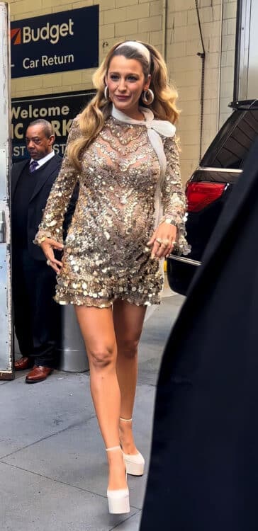 pregnant blake lively wearing a gold dress with a baby bump