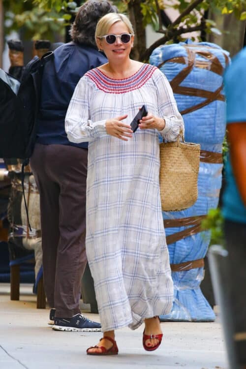 pregnant woman walking down the street in a plaid dress