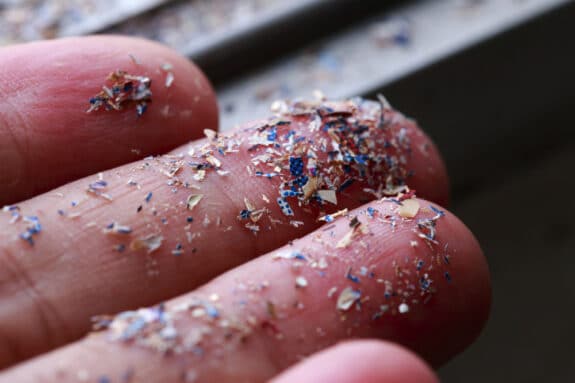 tiny plastic particles in a hand