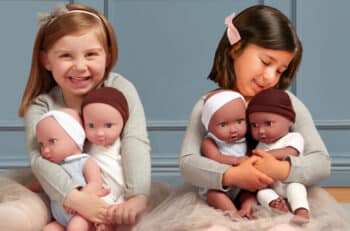 two girls each hold two baby doll twins