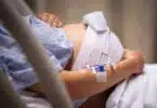 A pregnant woman having contractions, waiting to give birth in the hospital