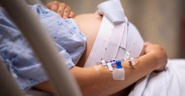 A pregnant woman having contractions, waiting to give birth in the hospital