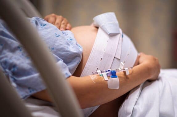 A pregnant woman having contractions, waiting to give birth in the hospital