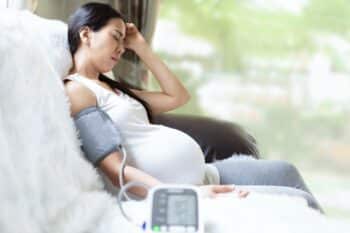pregnant woman is monitor blood pressure while she has headache to prevent hypertension during pregnancy