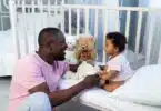 dad and baby son talking in the bedroom at home