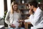 pregnant woman is being check out by her doctor