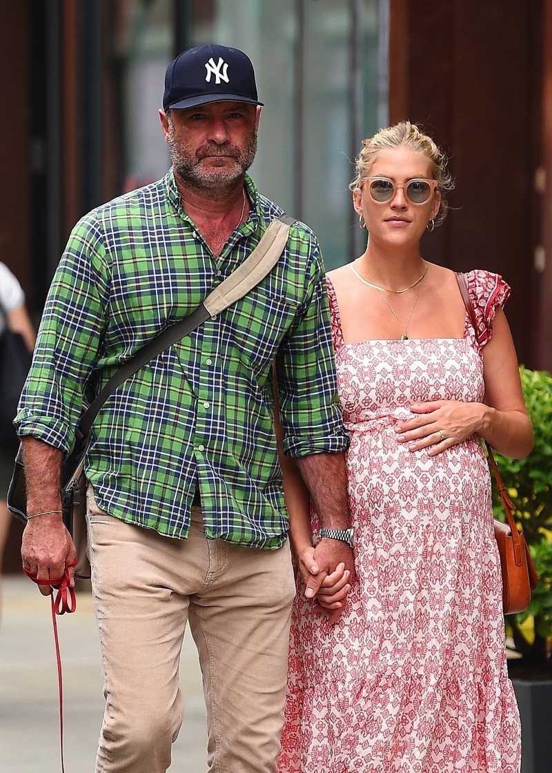 Liev Schreiber and pregnant wife Taylor Neisen hold hands as they get