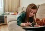 Preschool girl using a tablet computer at home