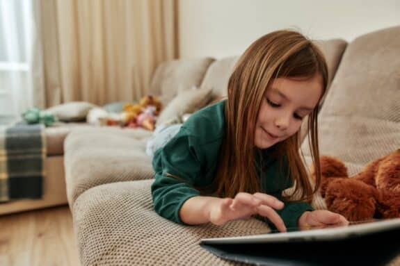  Preschool girl using a tablet computer at home 