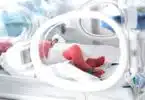 Baby in isolette in NICU