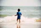 child swimming at the beach