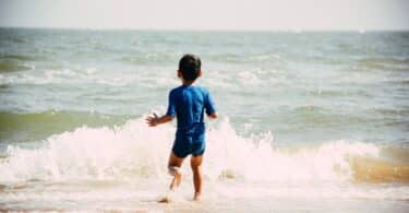 child swimming at the beach