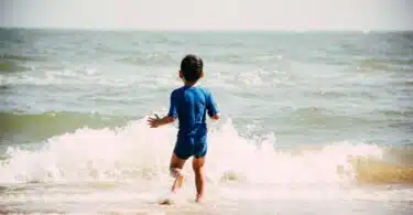 child swimming at the beach