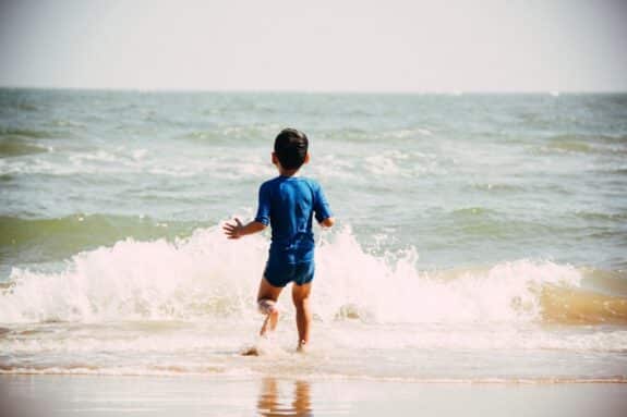 child swimming at the beach