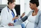 wellness check and a medical worker with a patient consulting about hypertension during pregnancy