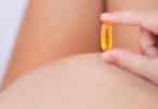 A pregnant mom take her vitamins. Omega and fish oil supplements